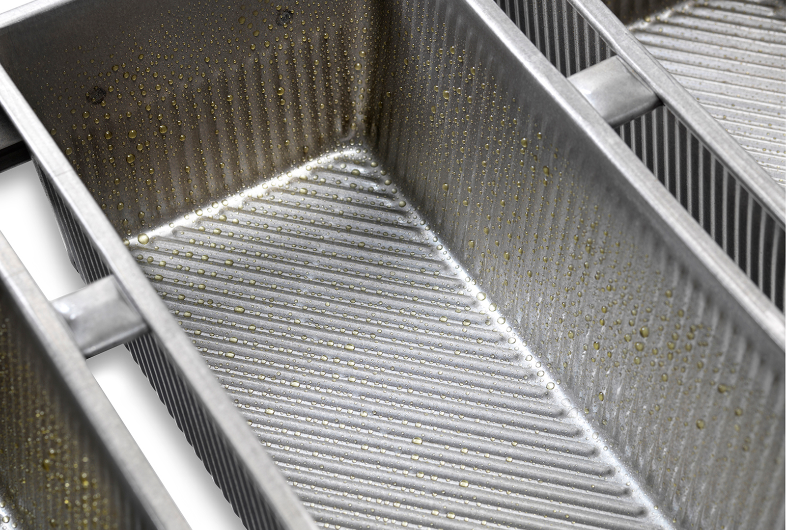 close up view of an oiled bread pan